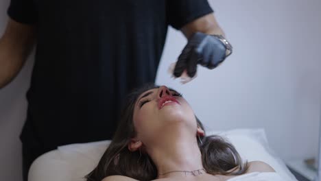woman undergoing lip filler treatment