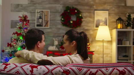 Back-view-of-romantic-couple-sitting-on-couch