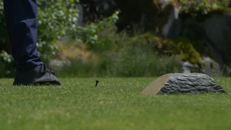 golfer swing driving ball with wood club onto the course