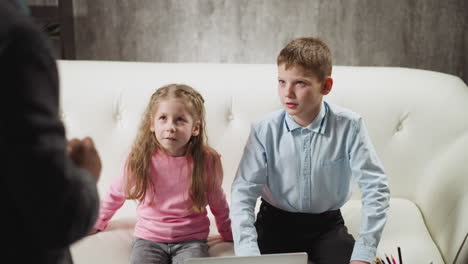 girl and boy look at cards with teacher checking knowledge