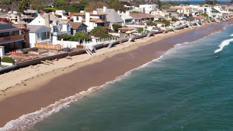 malibu beach coastline in california, luxury waterfront houses, aerial view along iconic beach landscape