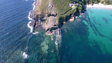 Drohnenaufnahme-Zeigt-Surgy-Klippe,-Umgeben-Von-Türkisfarbenem-Wasser-In-Sanxenxo