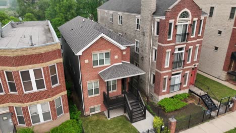 residential buildings: classic red-brick townhouses, gray roofs, green shrubs, and balconies