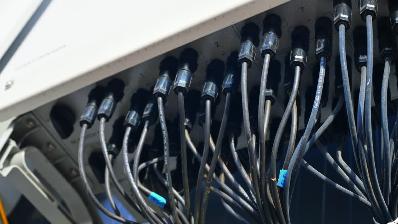 Close view of supporting systems for solar panels located on a manufacturing building , lots of connected wires. Ecology thematics