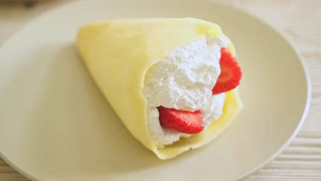 fresh strawberry and fresh cream crepe on plate