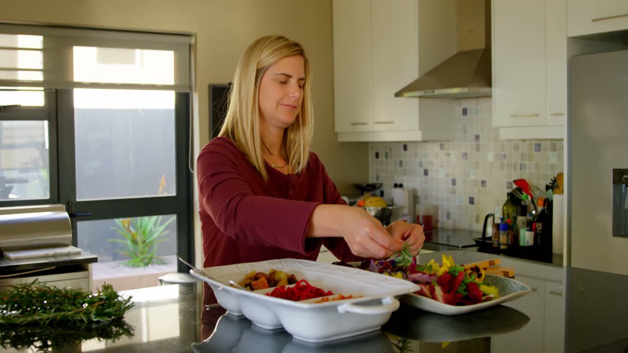 Beautiful woman preparing salad food in kitchen 4k