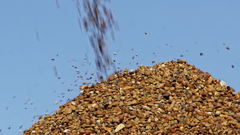 pile of crushed stone falling from crushing machine