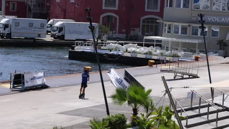 individual riding scooter along waterfront in napoli, italy