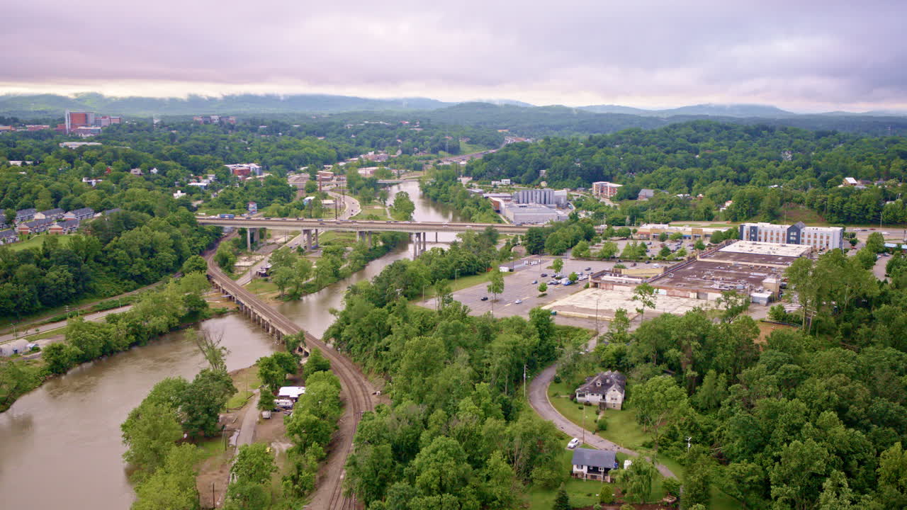 High drone shot over driftwood-choked banks of the French Broad River after recent floods