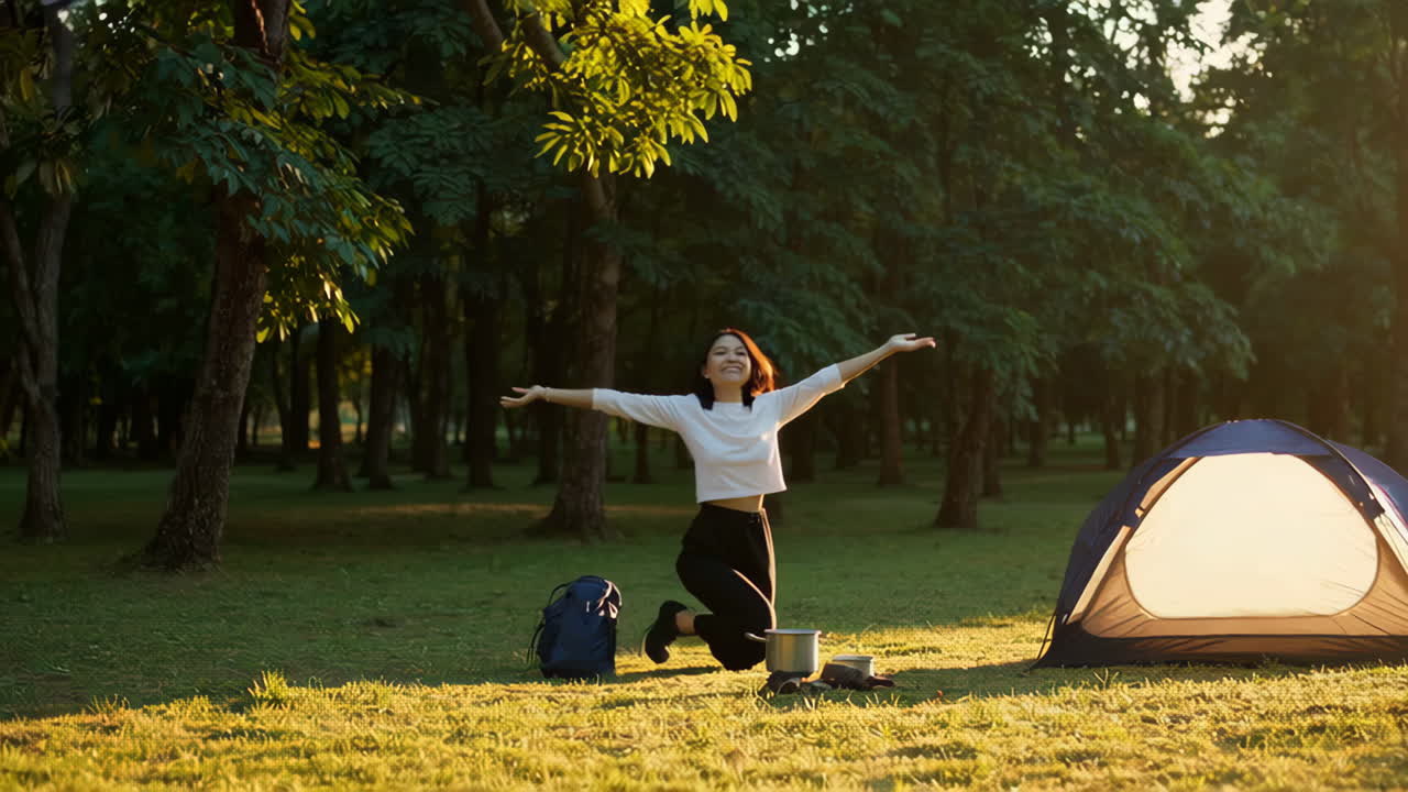 Woman Camping and Cooking Outdoors at Sunset