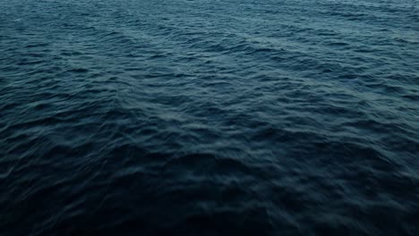 mysterious dark blue ocean water of the deep sea with textured current ripples