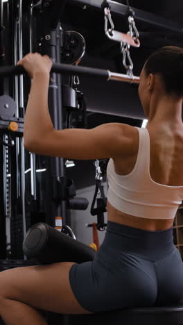 Woman Doing Lat Pulldowns in a Gym