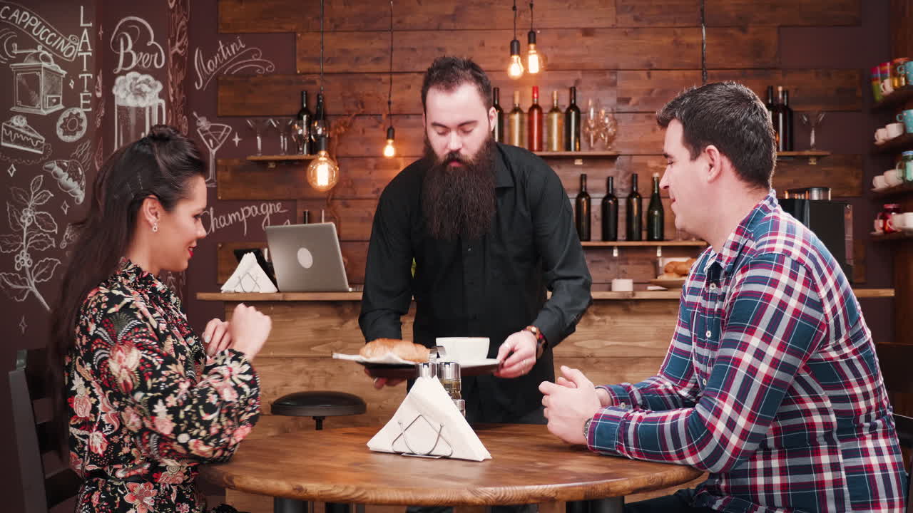 People at a restaurant ordering food and drinks