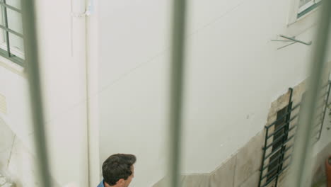 long shot of happy gay couple going down stairs on summer day