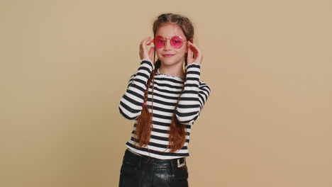 happy stylish preteen child girl kid wearing sunglasses charming smile flirting expressing optimism