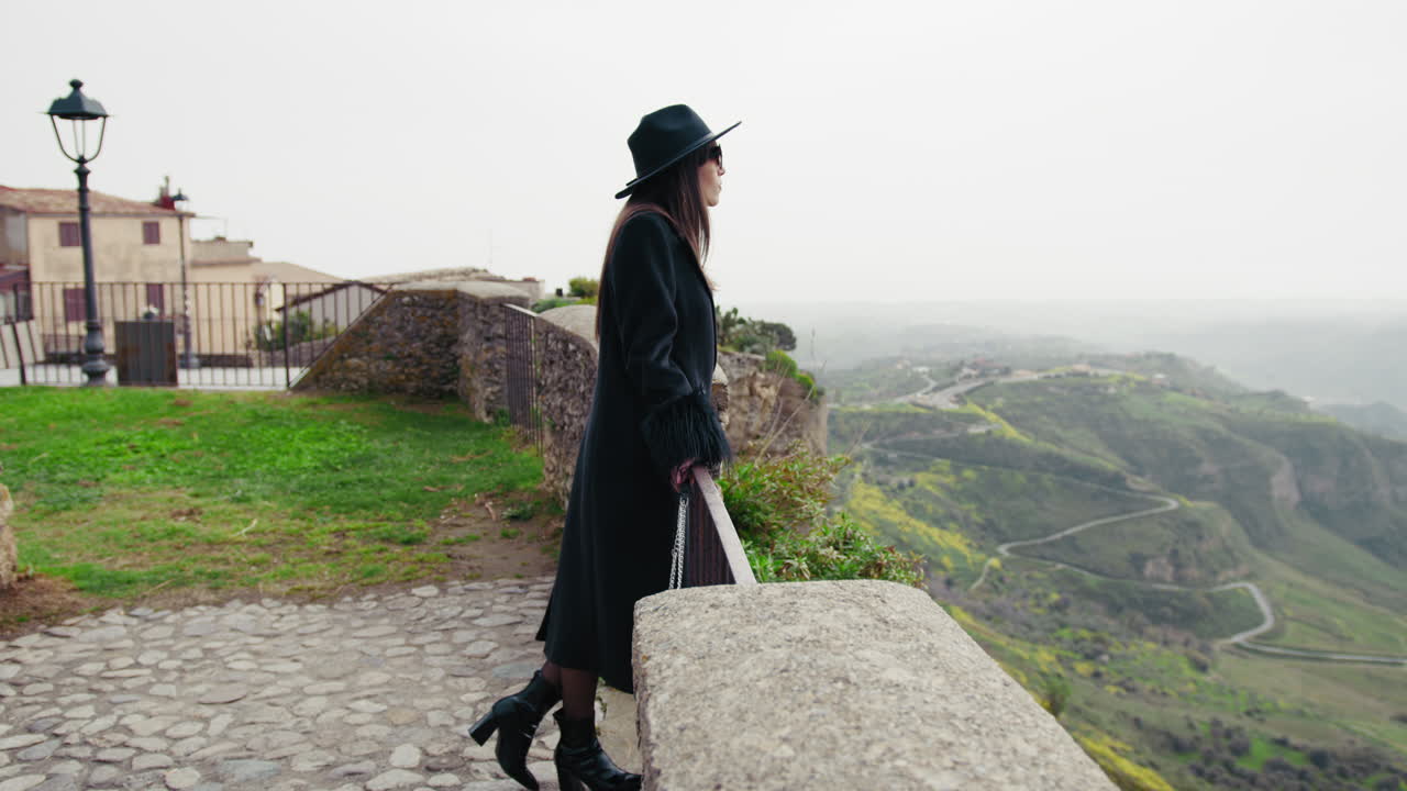 Woman Having A Walk And Watching The Landscape Behind The Railing