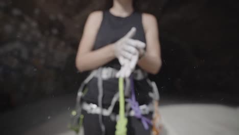 rock climbing grip chalk dust applying by a climber girl