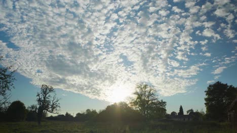 A-beautiful-clue-sky-sunset-with-clouds-over-a-field-in-the-countryside