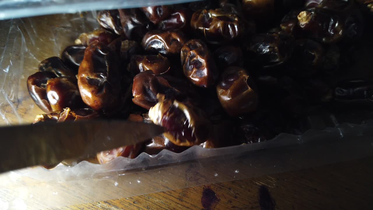 a bunch of dried dates in a plastic container, dried dates for the Hajj