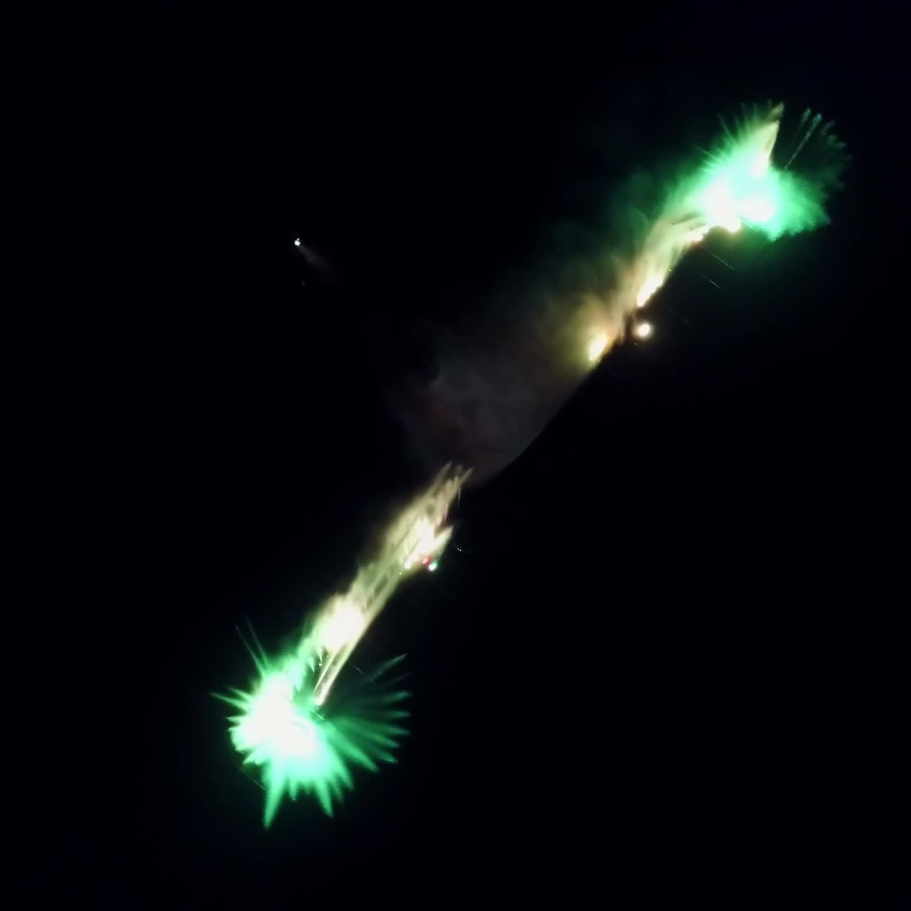 Water Music Fountain In Night. Aerial shot of the dancing colorful fountain with reflection on water at night