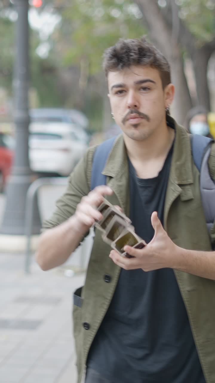 A man performing a card trick outdoors