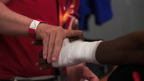 boxer wraps hands before a fight