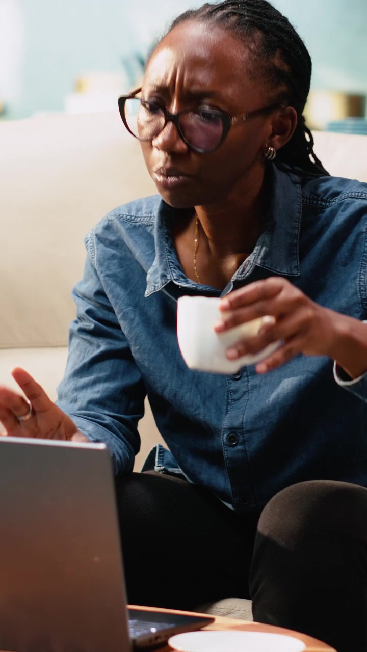 Vertical Video Woman attending online video conference from her apartment