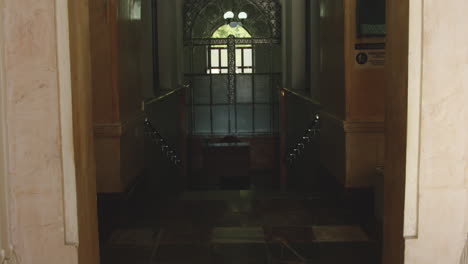 empty passage and a massive, ornamental wall clock