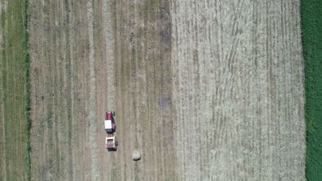 aerial top down of tractor harvest machine in farm land field, food chain inflation war concept