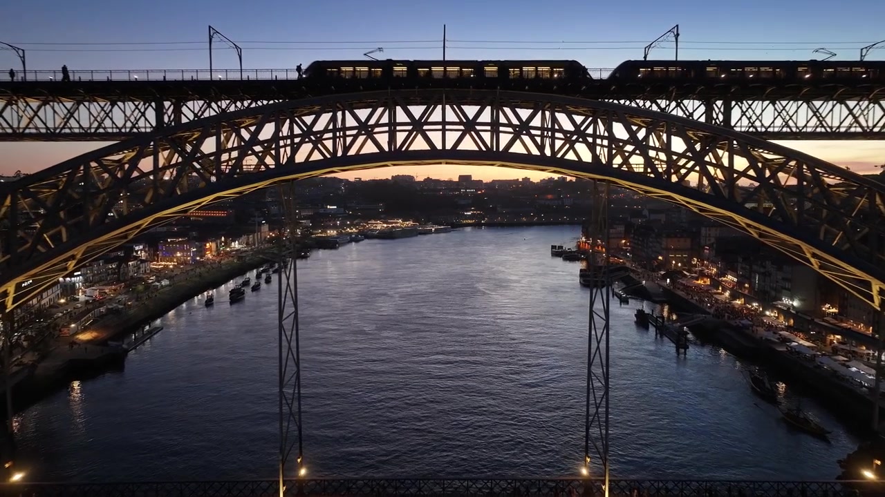 Sunset Dom Luis I Bridge At Porto In District Of Porto Portugal. Sunset Skyline Scene. Illuminated Bridge Landscape. Dom Luis I Bridge At District Of Porto Portugal. Railroad Transportation.