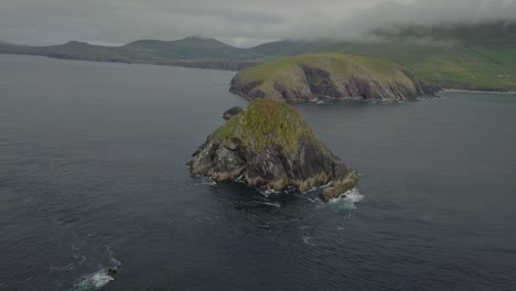 beautiful aerial view of jagged rock formations stretching out to sea from dunmore head in ireland along the wild atlantic way