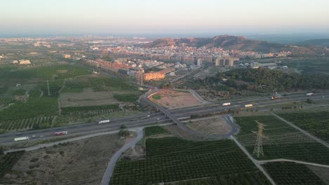 aerial view of city and highway at sunset