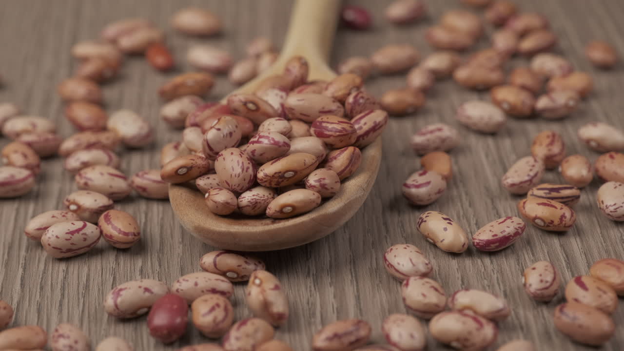 Red beans legumes on wooden spoon rotating, healthy nutrition protein source