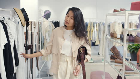 woman shopping for clothes and shoes in a fashion boutique