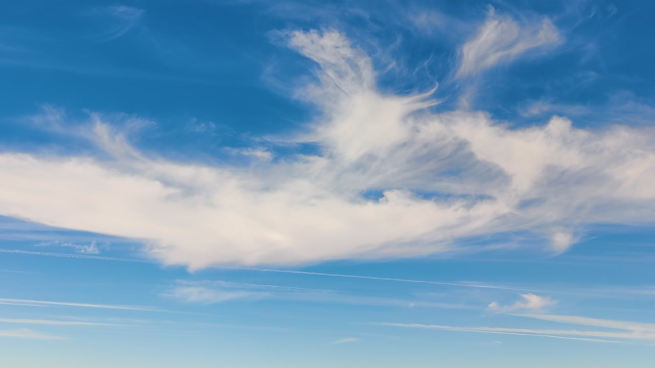 Serene afternoon clouds float in a clear blue sky, 60 fps calmness