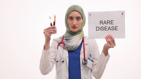 doctor holding 'rare disease' sign and blood samples