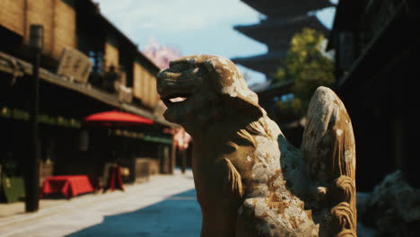 stone lion statue in front of a japanese temple