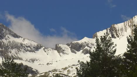 Snow-covered-mountain-landscape-above-trees-in-Pyrenees,-Spain