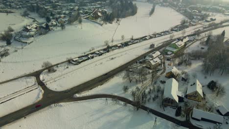 Aerial-shot-of-a-snow-covered-mountain-town-in-fog