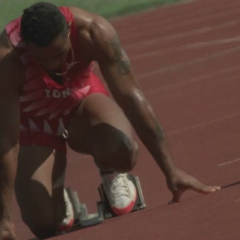 a runner leaves the starting block on a track