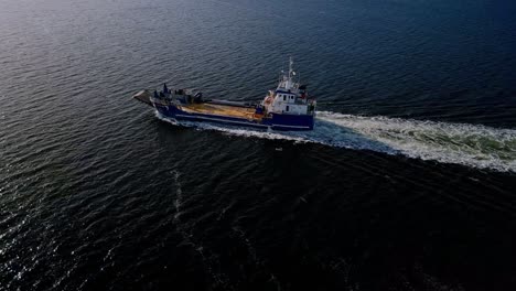 landing craft leaving wake in the calm sea in tasmania, australia