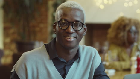 portrait of happy african american man in cafe
