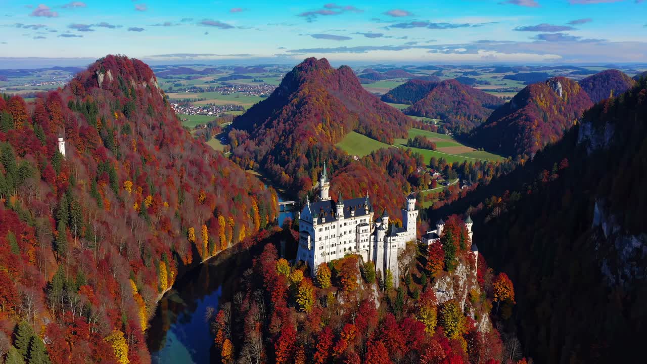 Aerial video showcasing a majestic castle surrounded by vibrant autumn foliage and rolling hills