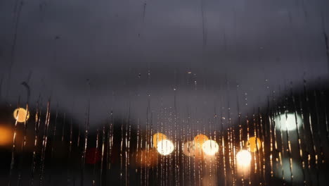 rainy night cityscape through a window
