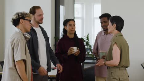 diverse group of colleagues interacting in an office
