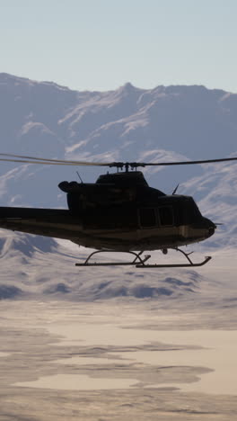 a helicopter flying over a desert landscape