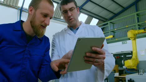 ingenieros robóticos discutiendo sobre una tableta digital 4k