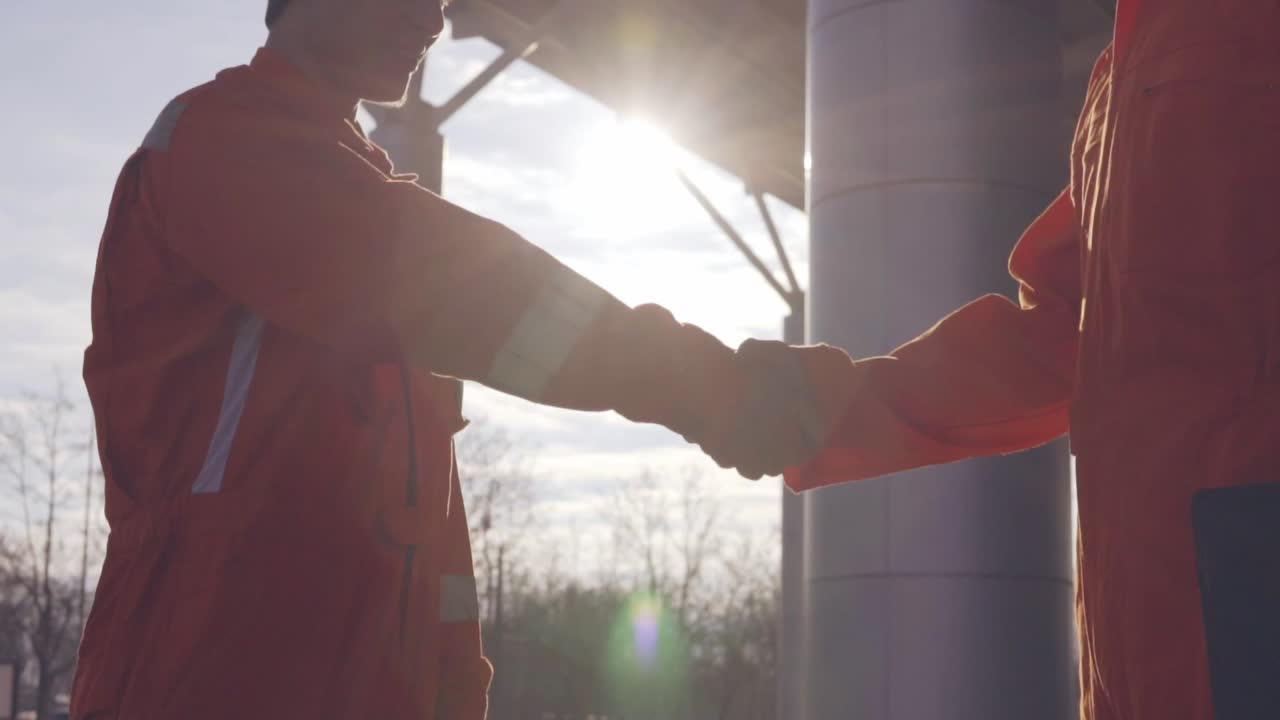 Premium stock video - Two construction workers in orange uniform and ...