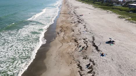 cocoa beach coastline with people on vacation in florida, aerial