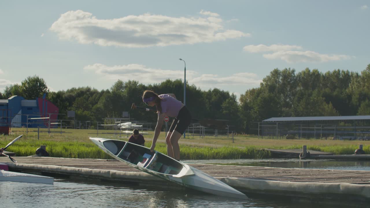 People with kayaks on a dock
